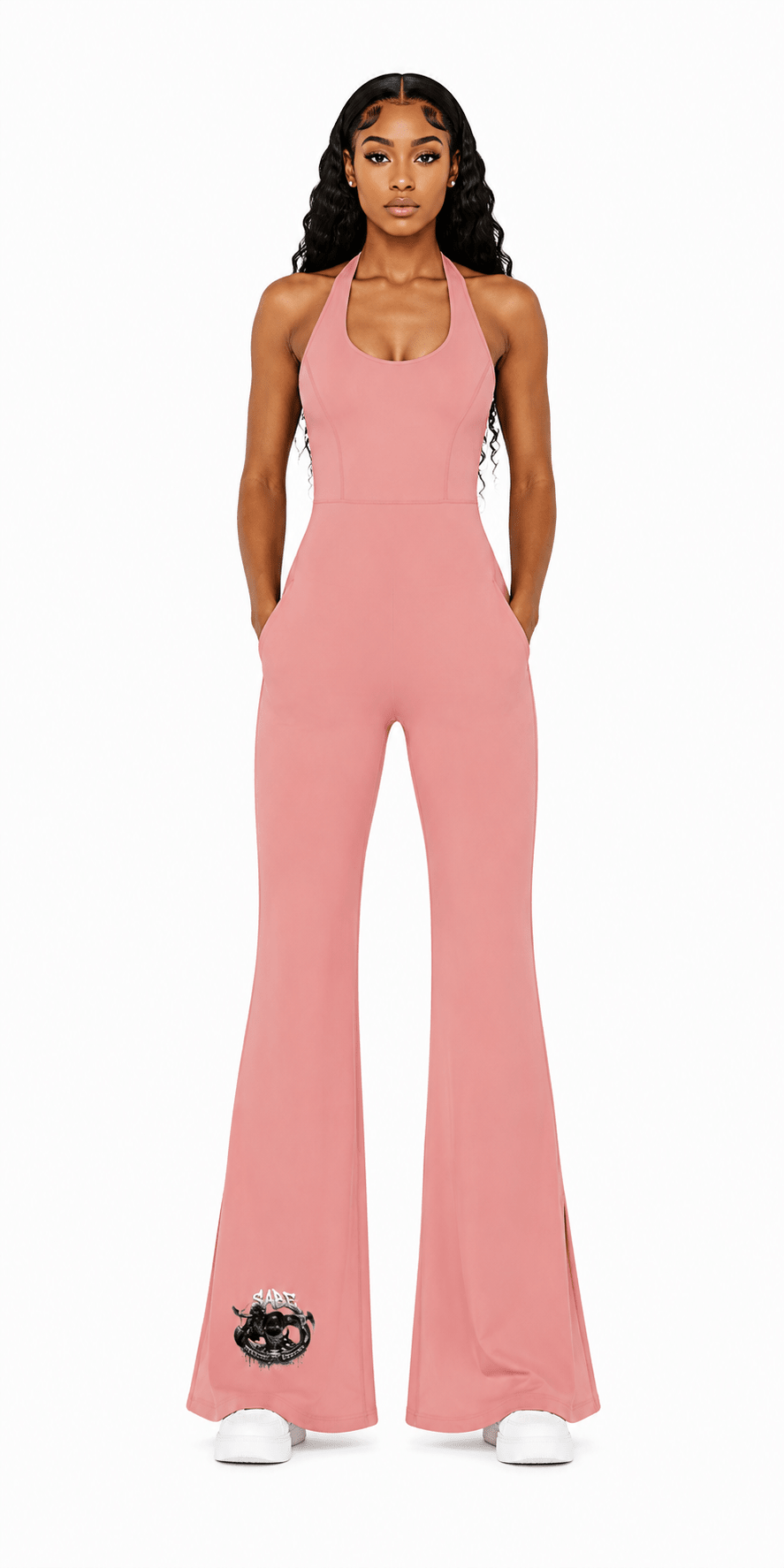 female model in a pink romper on a white background