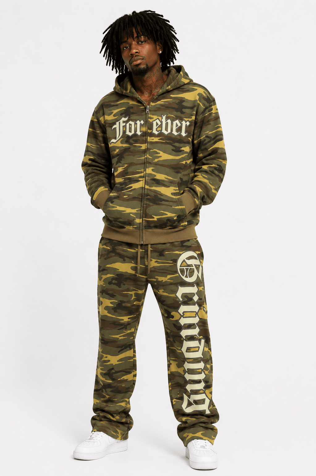 male model in a camo outfit on a white backkground
