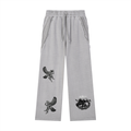 Gray sweatpants with black embroidered designs on a white background