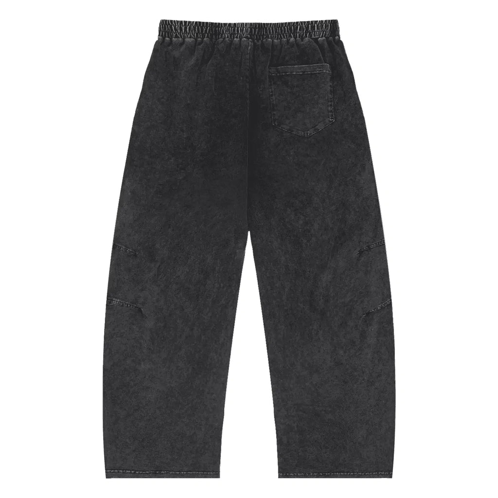 Black pants with 'ETHER' and 'REAL' text on a white background