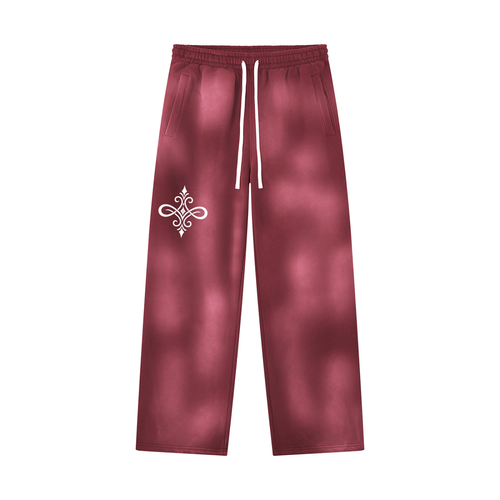 A pair of maroon sweatpants with a white drawstring and a white ornamental emblem on the left thigh, displayed against a solid white background.