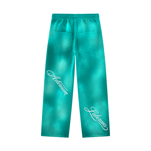 Turquoise tie-dye sweatpants with white cursive 'Halloween' text printed on both legs, featuring an elastic waistband and two back patch pockets, shown against a plain white background.