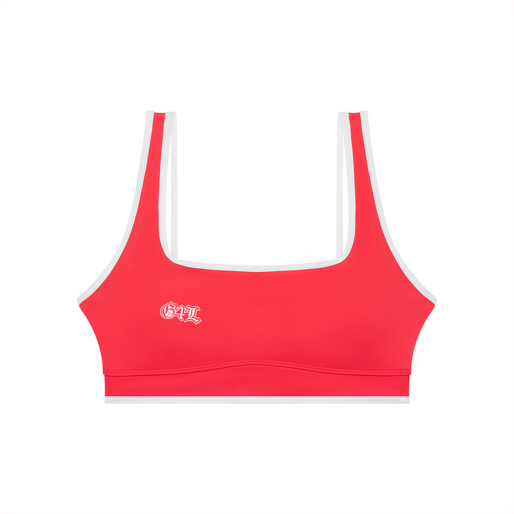 Red sports bra with white straps on a white background