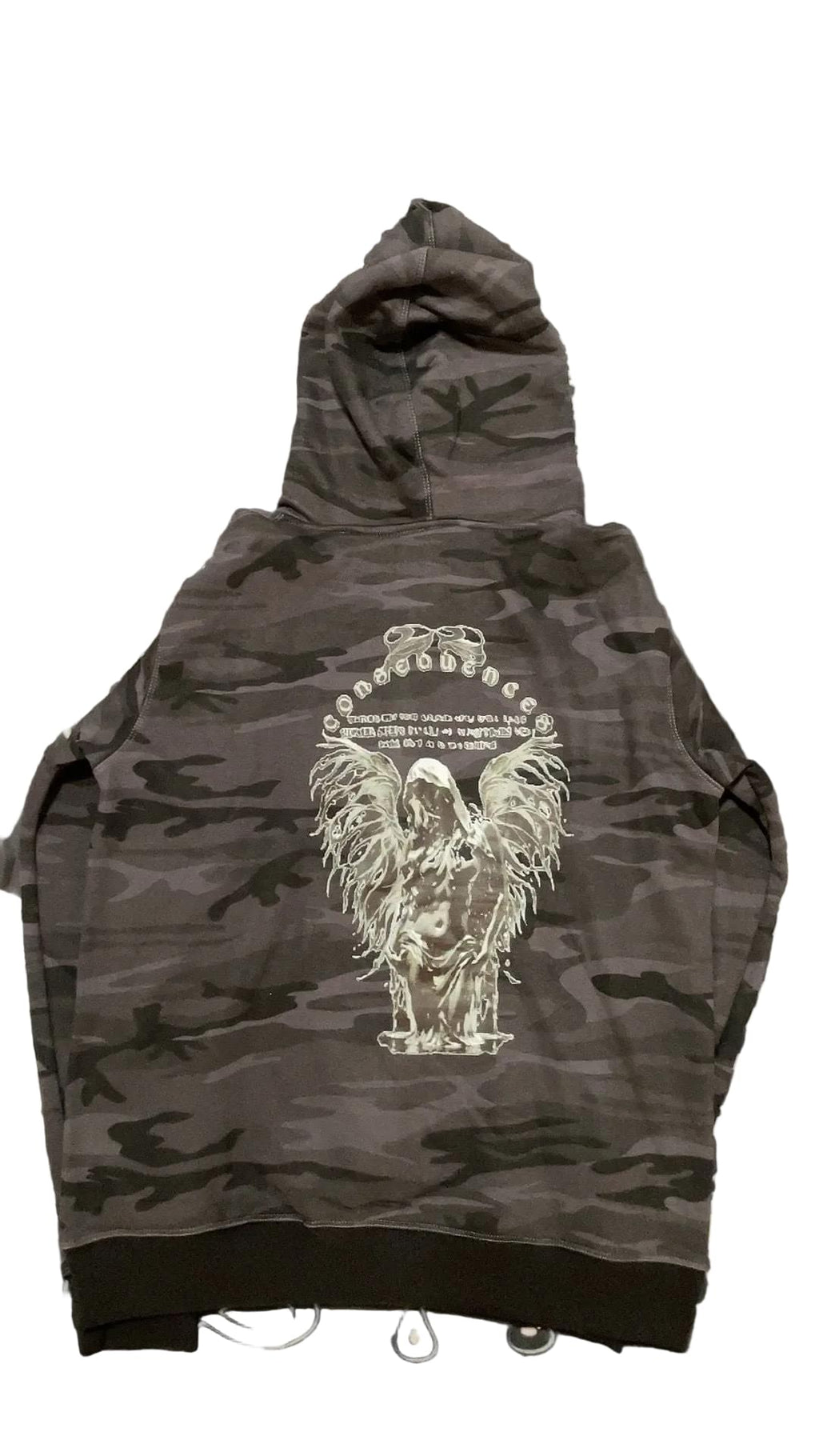Black camouflage hoodie with a white graphic design on a patterned background