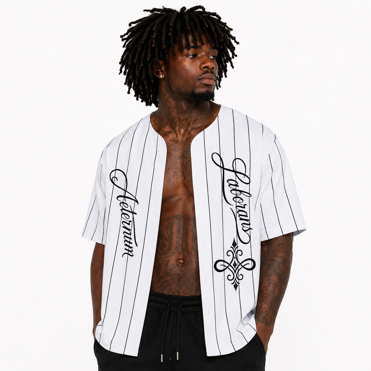 A man wearing a white short-sleeve baseball-style shirt with thin black pinstripes and black script text on the front, photographed against a plain light gray studio background.