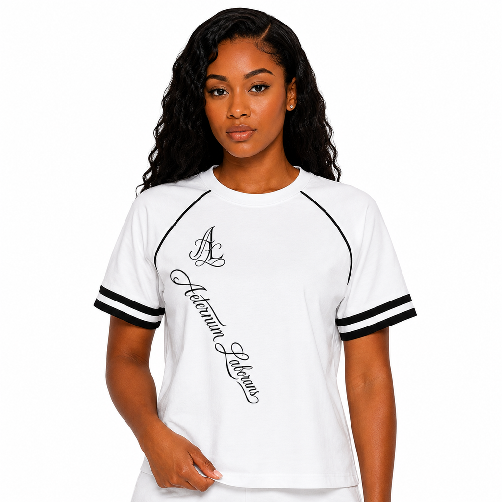 A woman modeling a white short-sleeve t-shirt with black double stripes on the sleeves and black script text reading 'Autumn Leaves' on the front.