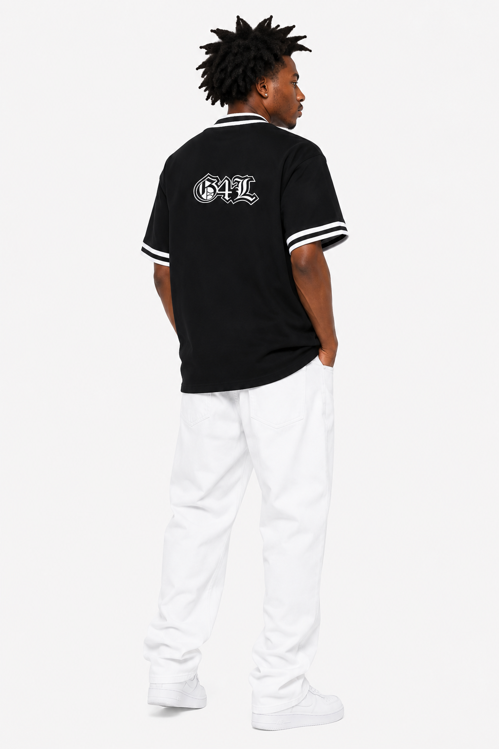 Person wearing a black polo shirt with white lettering and white pants on a white background