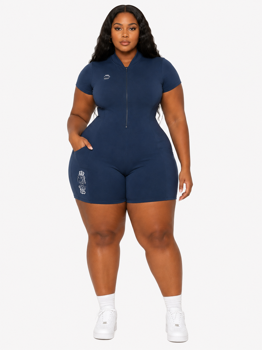Woman wearing a navy blue romper on a white background