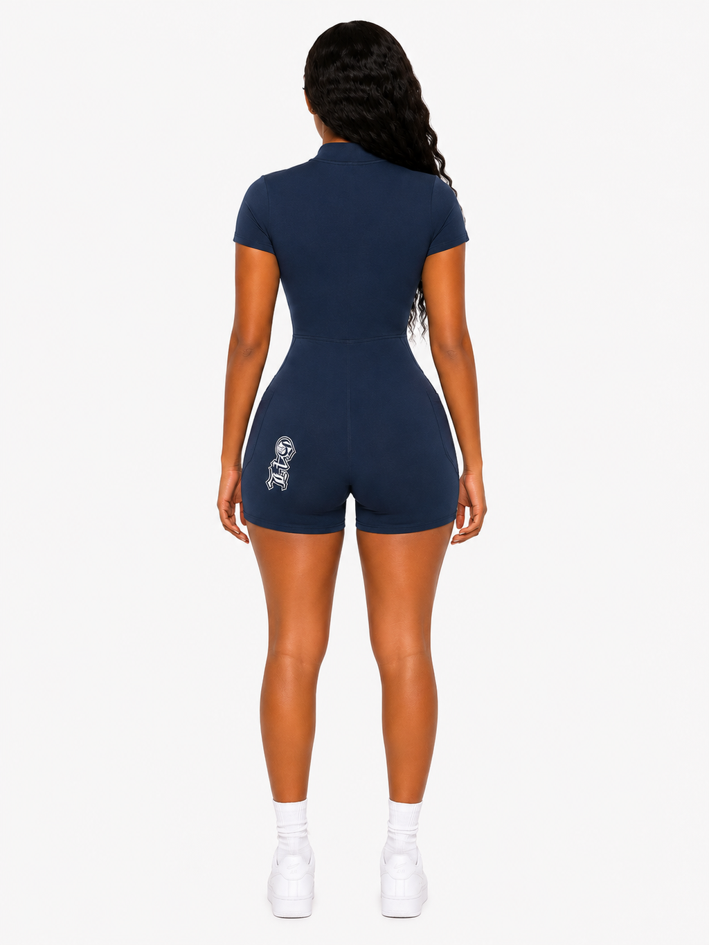 Navy blue romper worn by a model on a white background