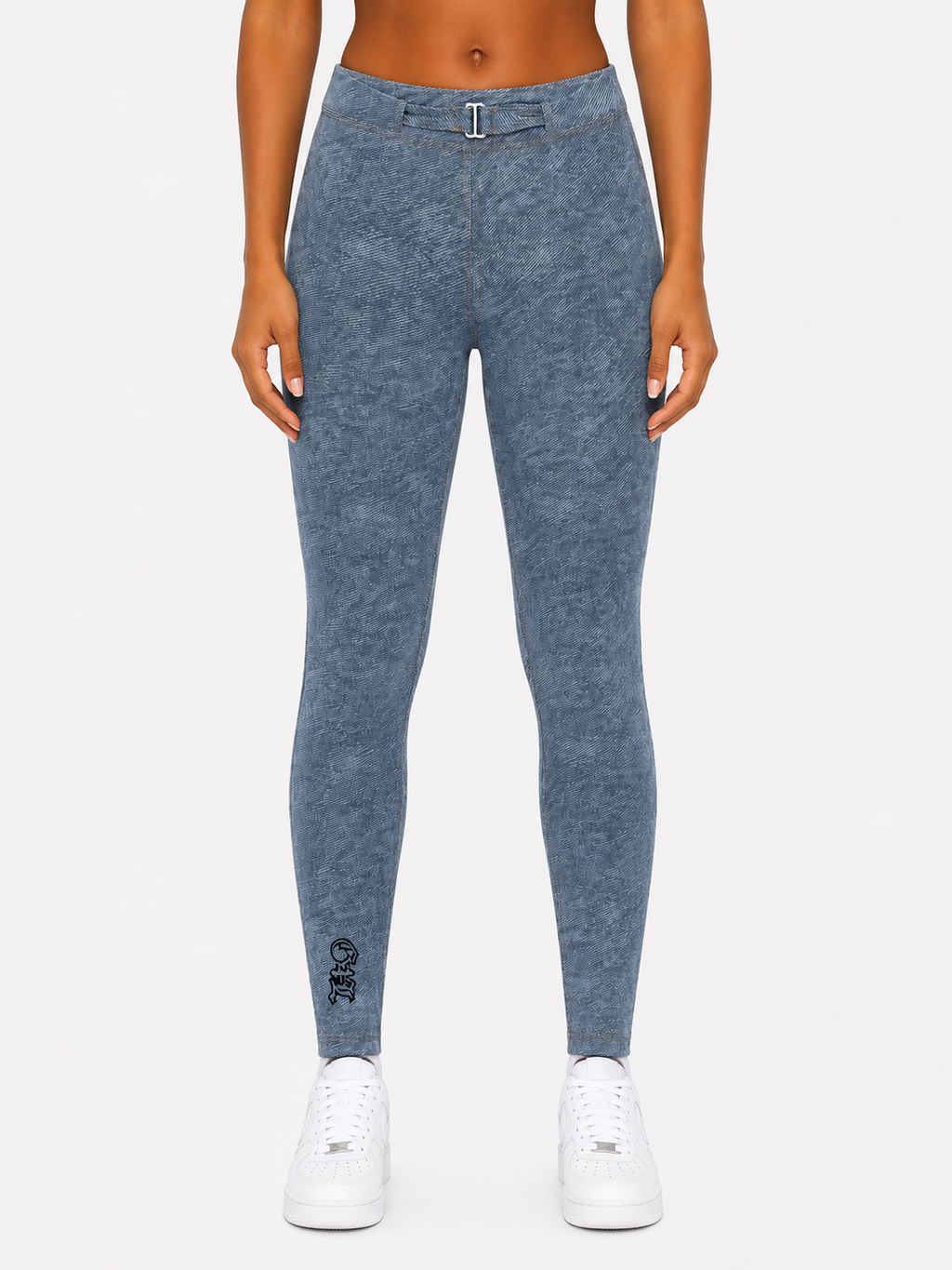 Person wearing blue leggings with a small logo on a white background