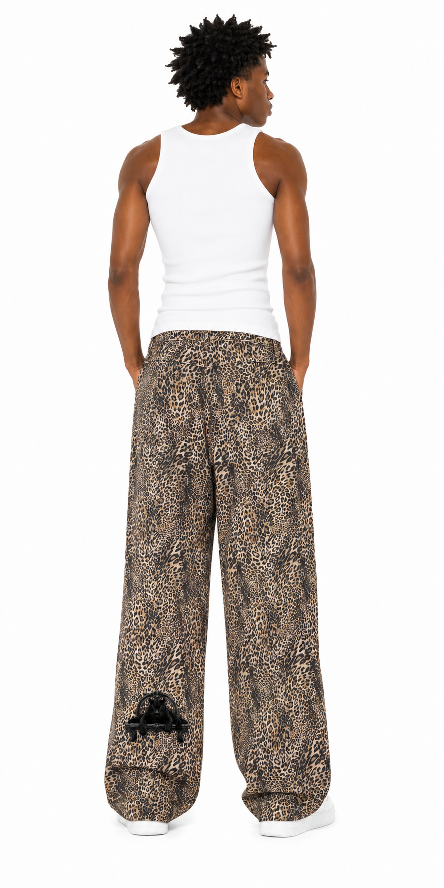 Person wearing a white tank top and patterned wide-leg pants on a white background