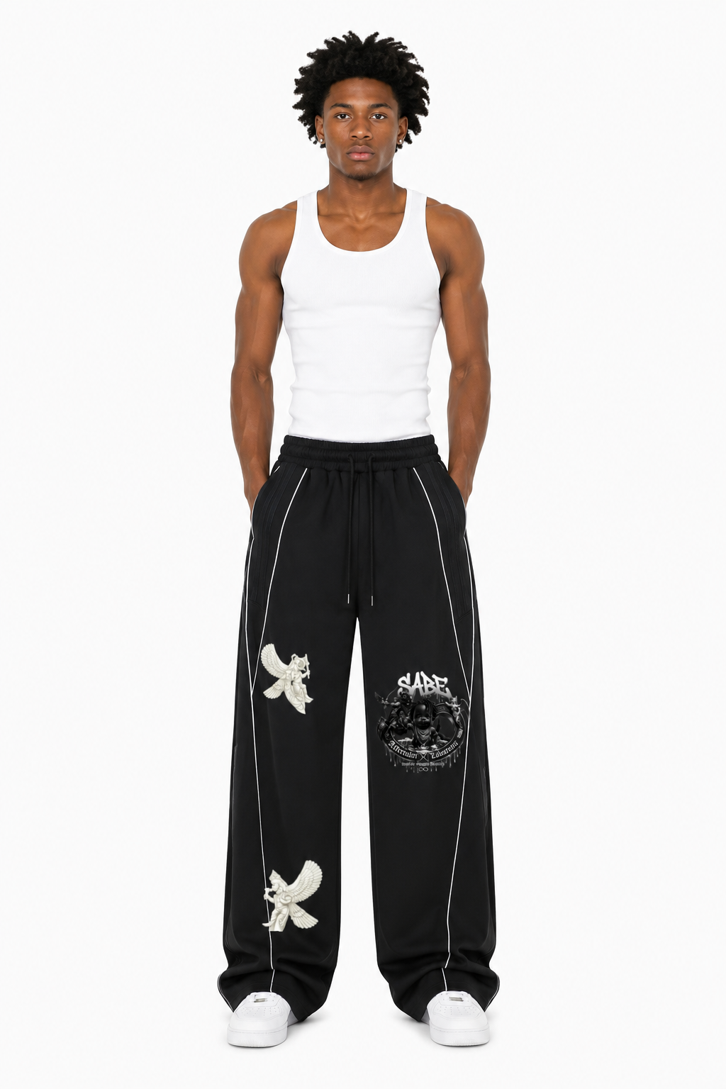 Man wearing black pants with white designs and a white tank top on a white background