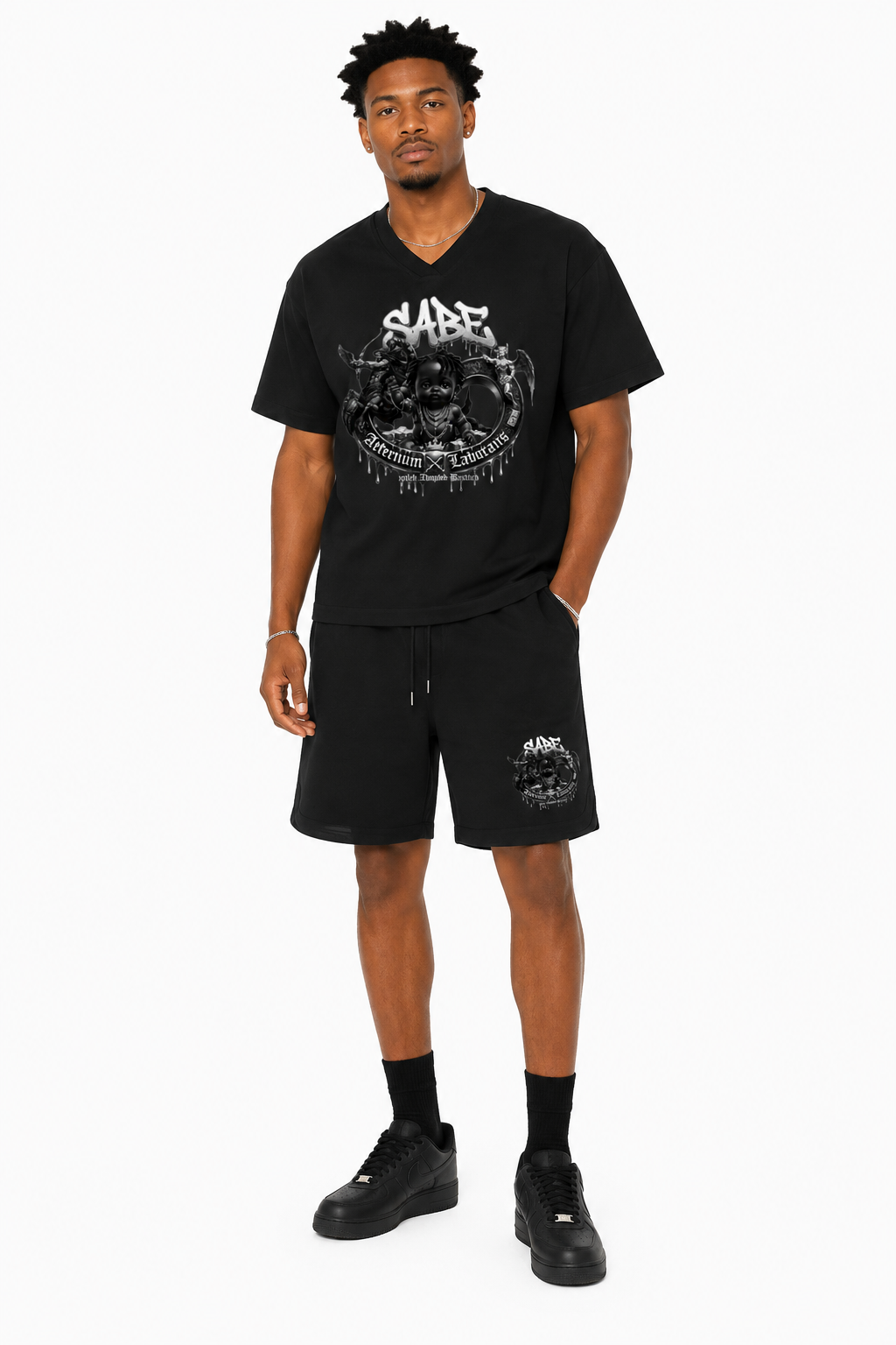 Man wearing a black graphic t-shirt and shorts on a white background