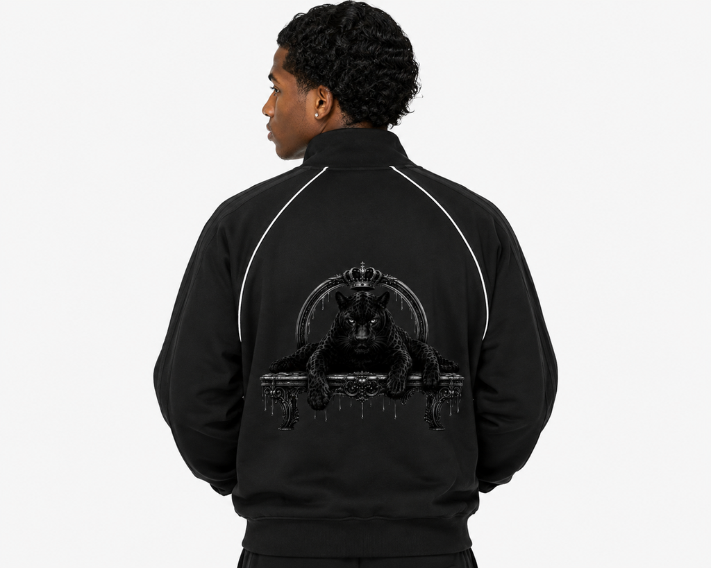 Person wearing a black jacket with a graphic design on the back against a white background