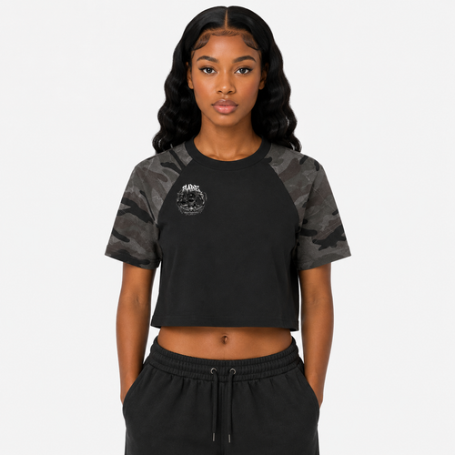 Woman wearing a black and gray camouflage t-shirt with a logo on a white background