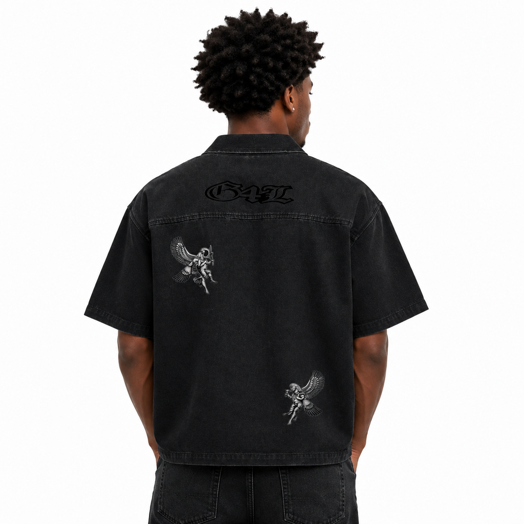 Person wearing a black shirt with designs on the back, on a white background