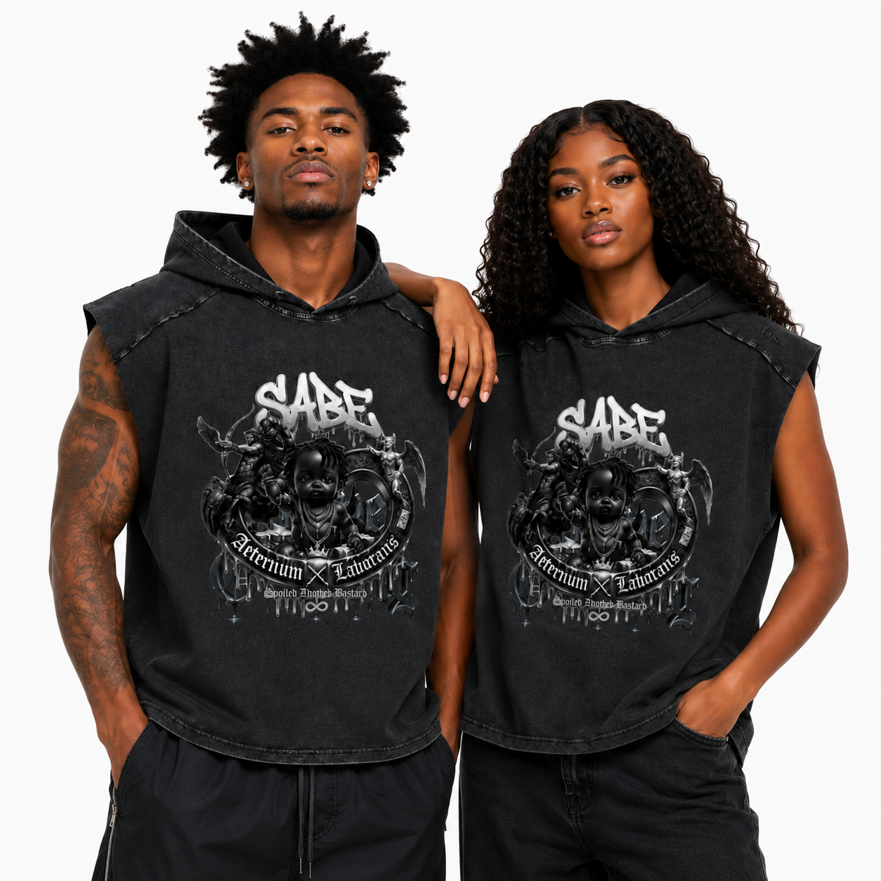 Two people wearing black sleeveless hoodies with a graphic design and text on a white background