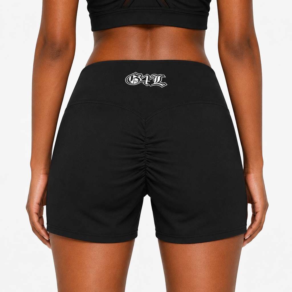 Black athletic shorts with a logo on the back worn by a person against a white background