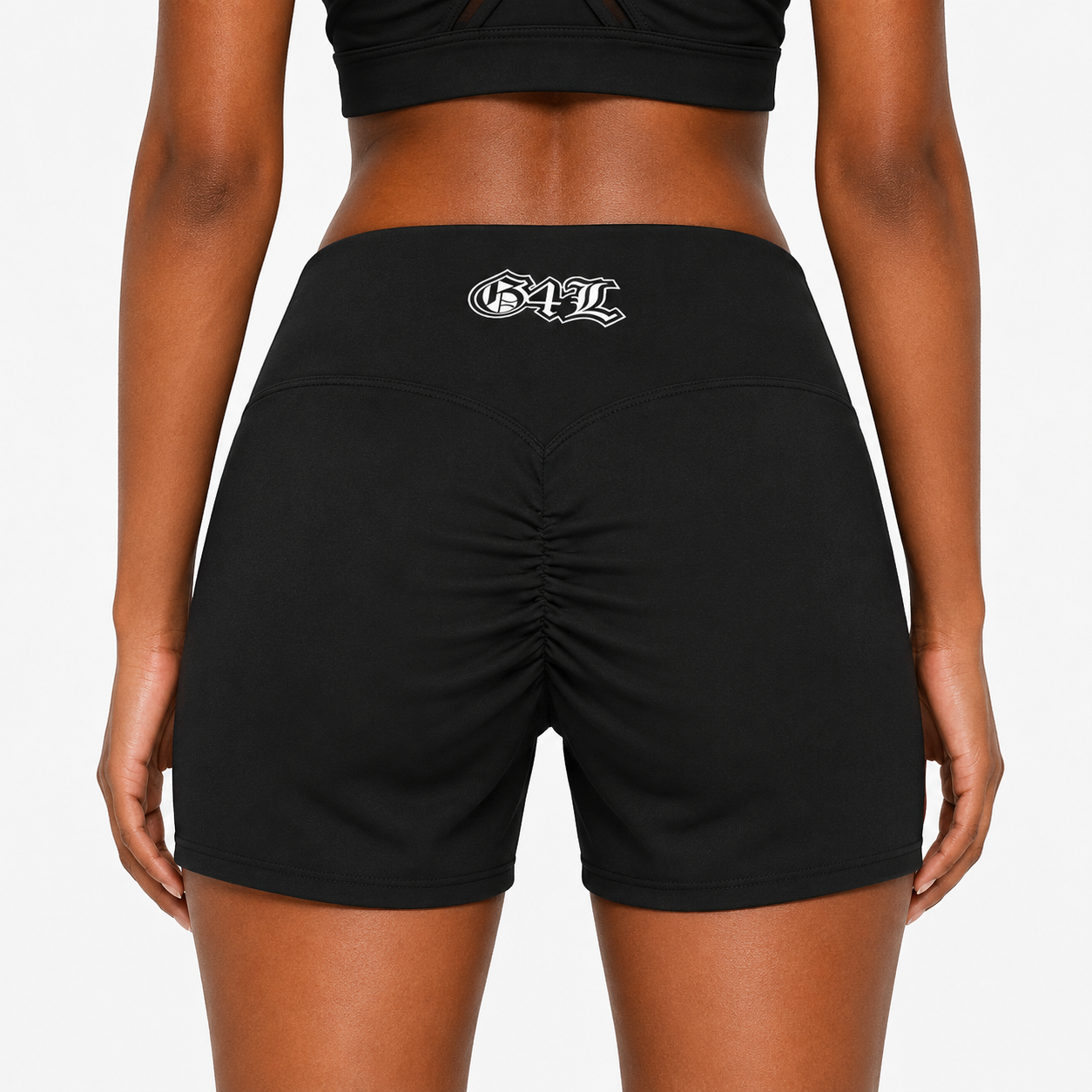 Black athletic shorts with a logo on the back worn by a person against a white background