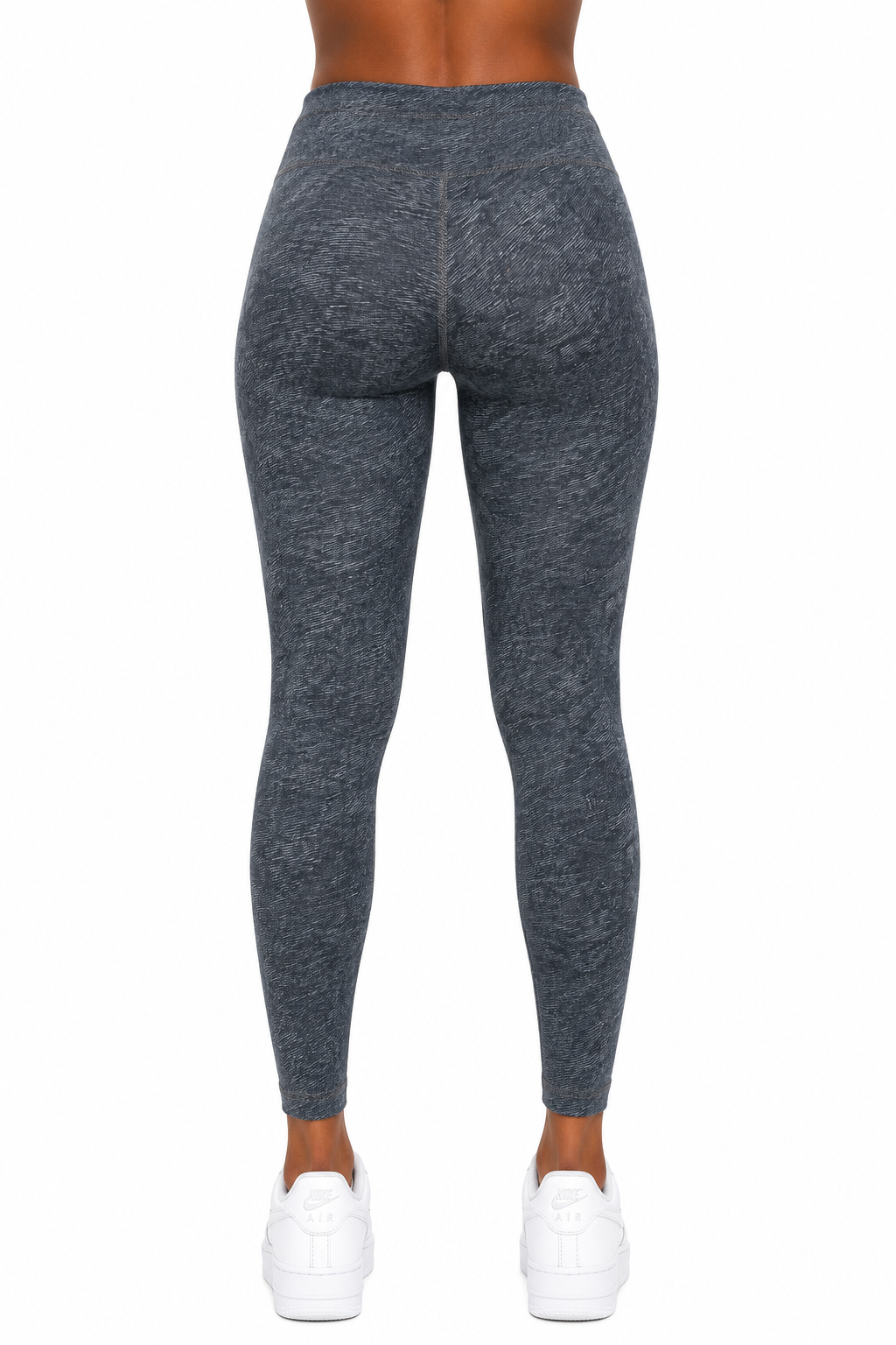 Dark gray leggings worn by a person on a white background