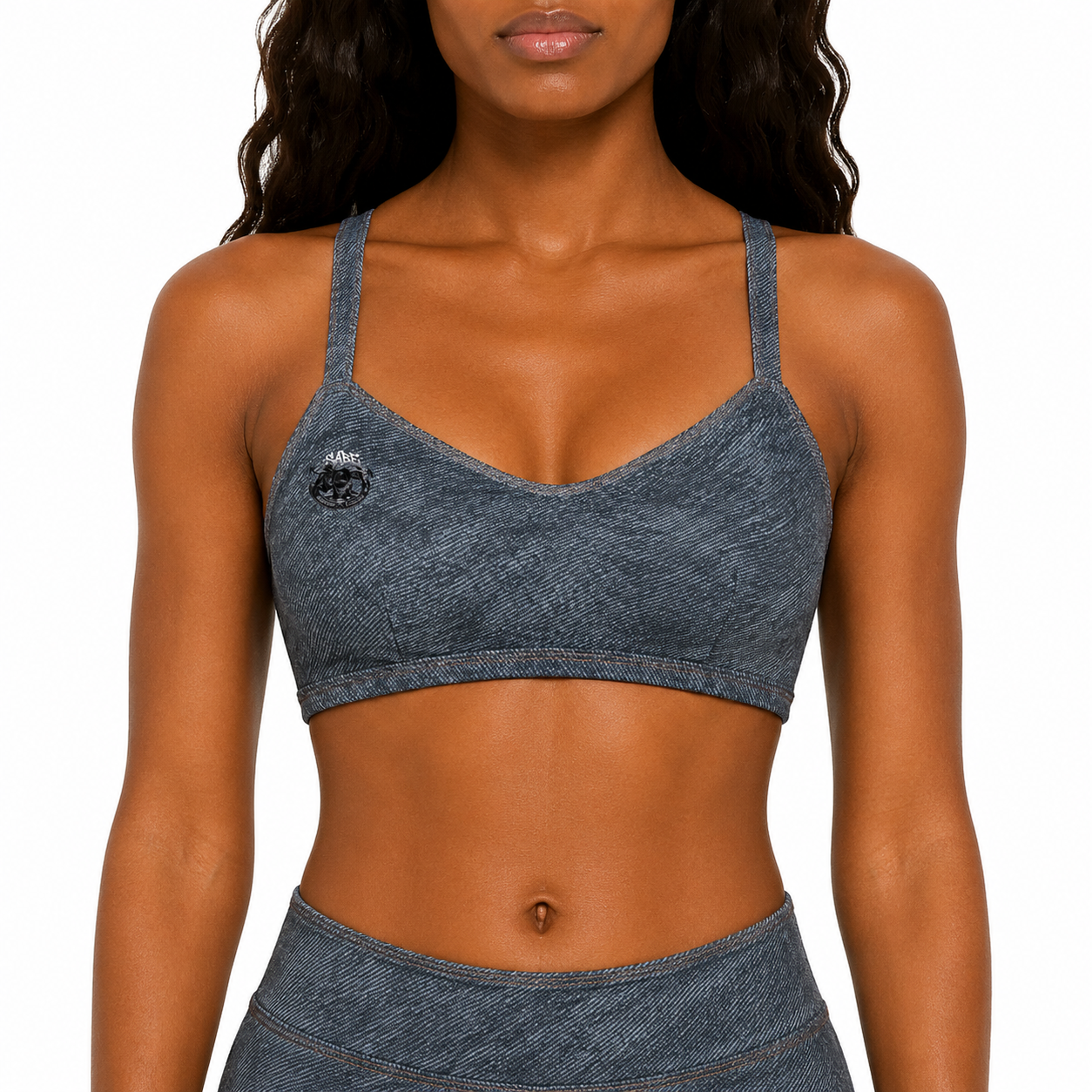 Woman wearing a blue denim-style sports bra and leggings on a white background