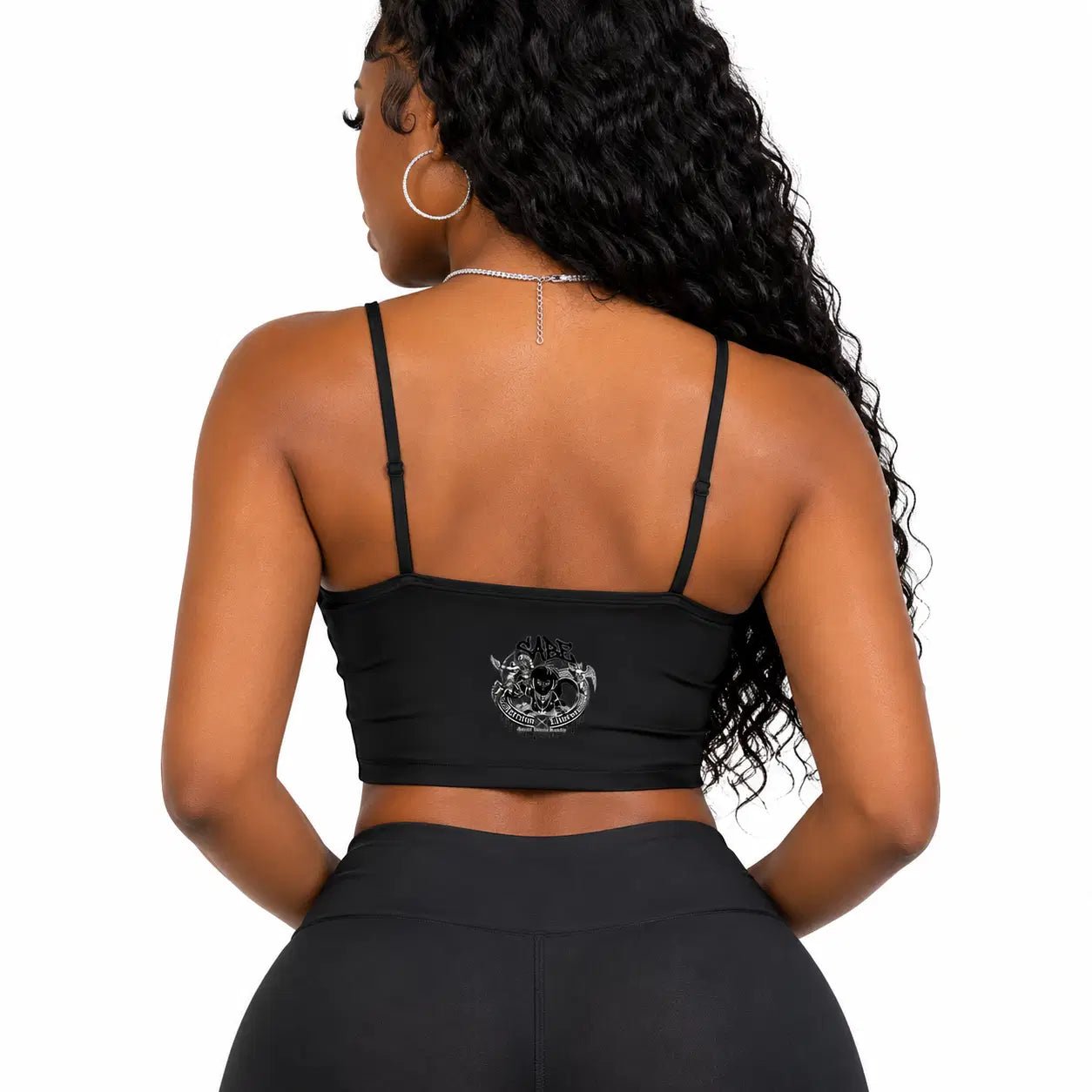 Woman wearing a black sports bra with a logo on a white background