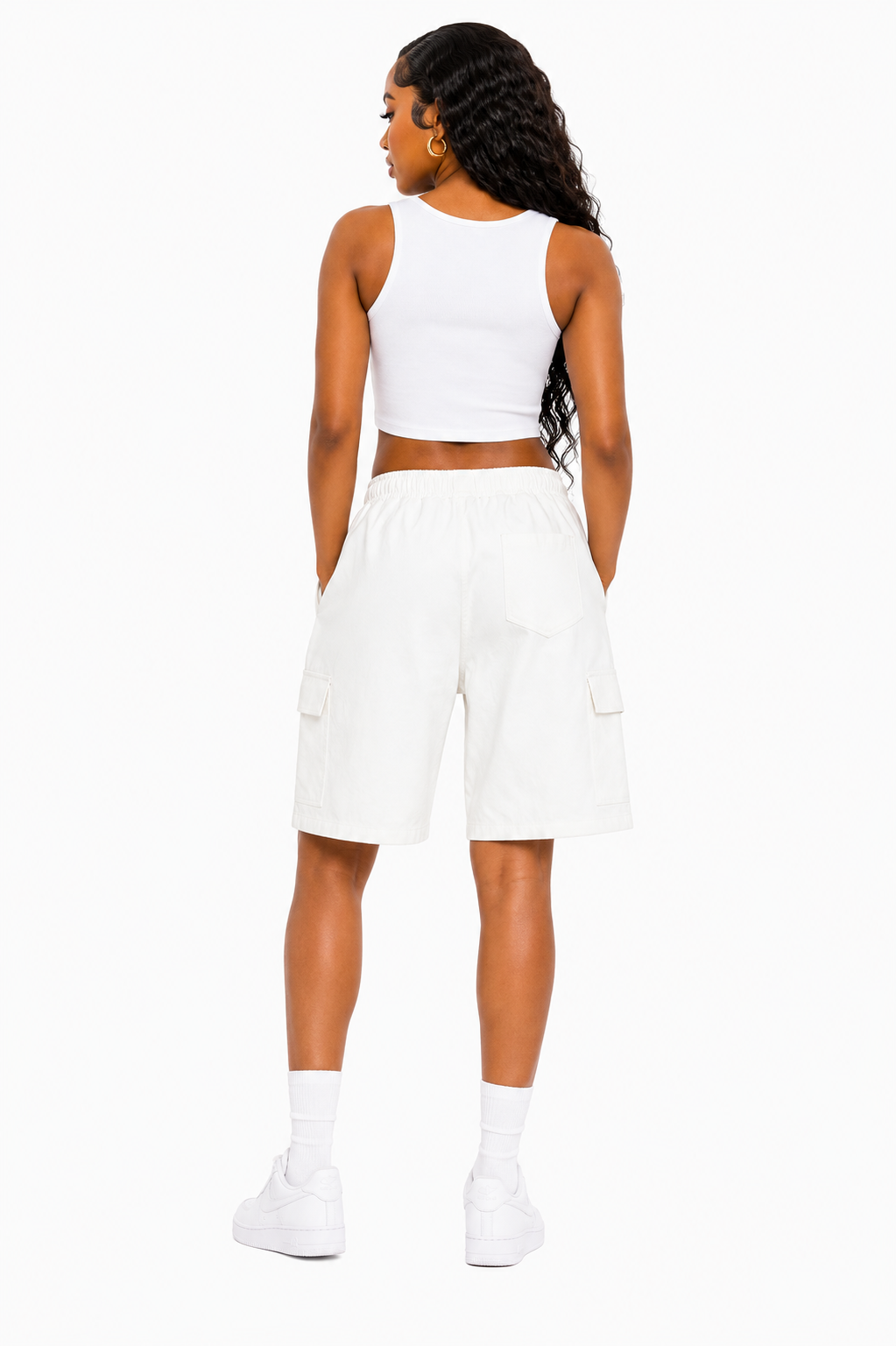 Person wearing a white sleeveless top and shorts on a white background