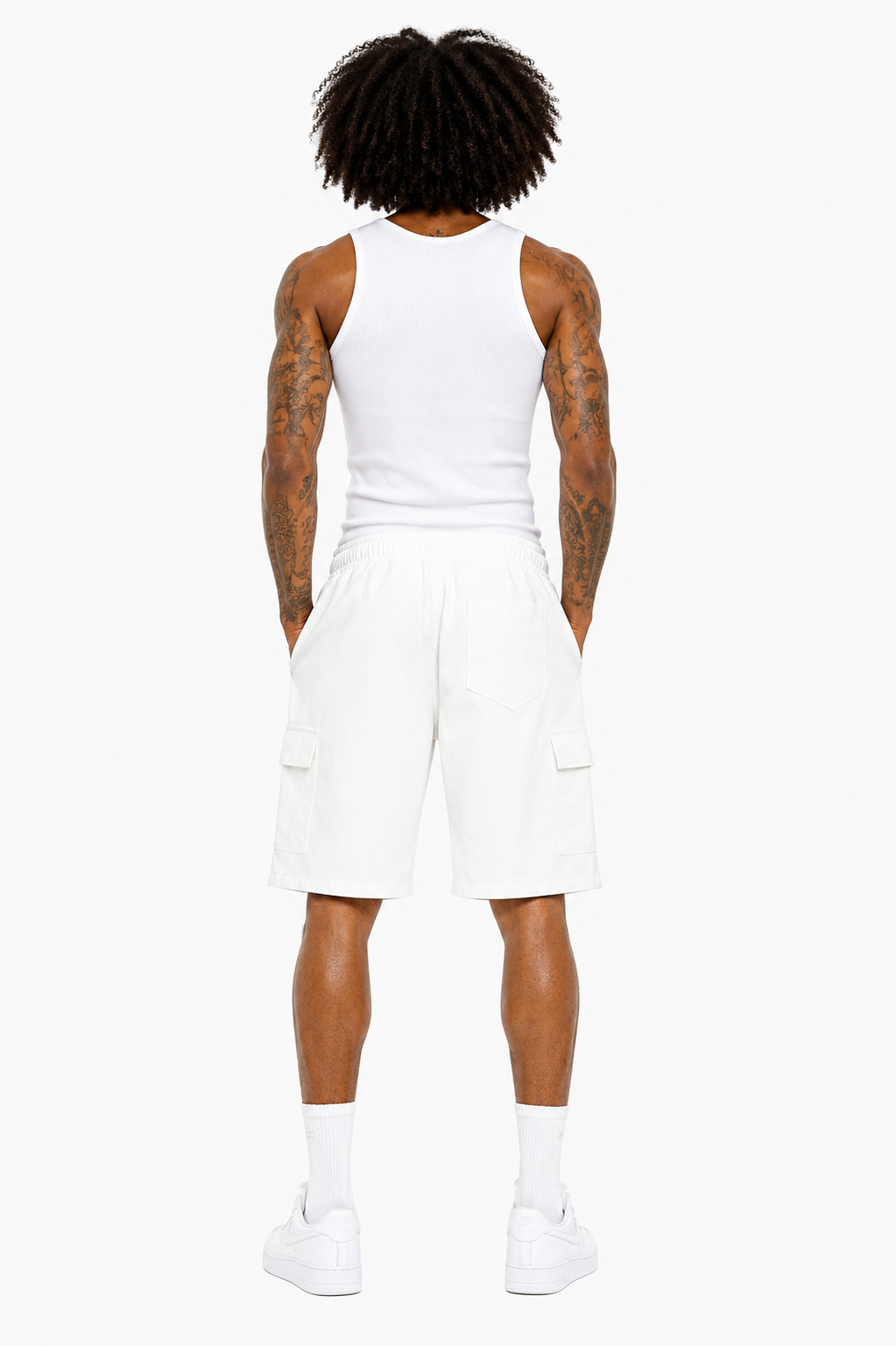 Person wearing a white tank top and shorts on a white background
