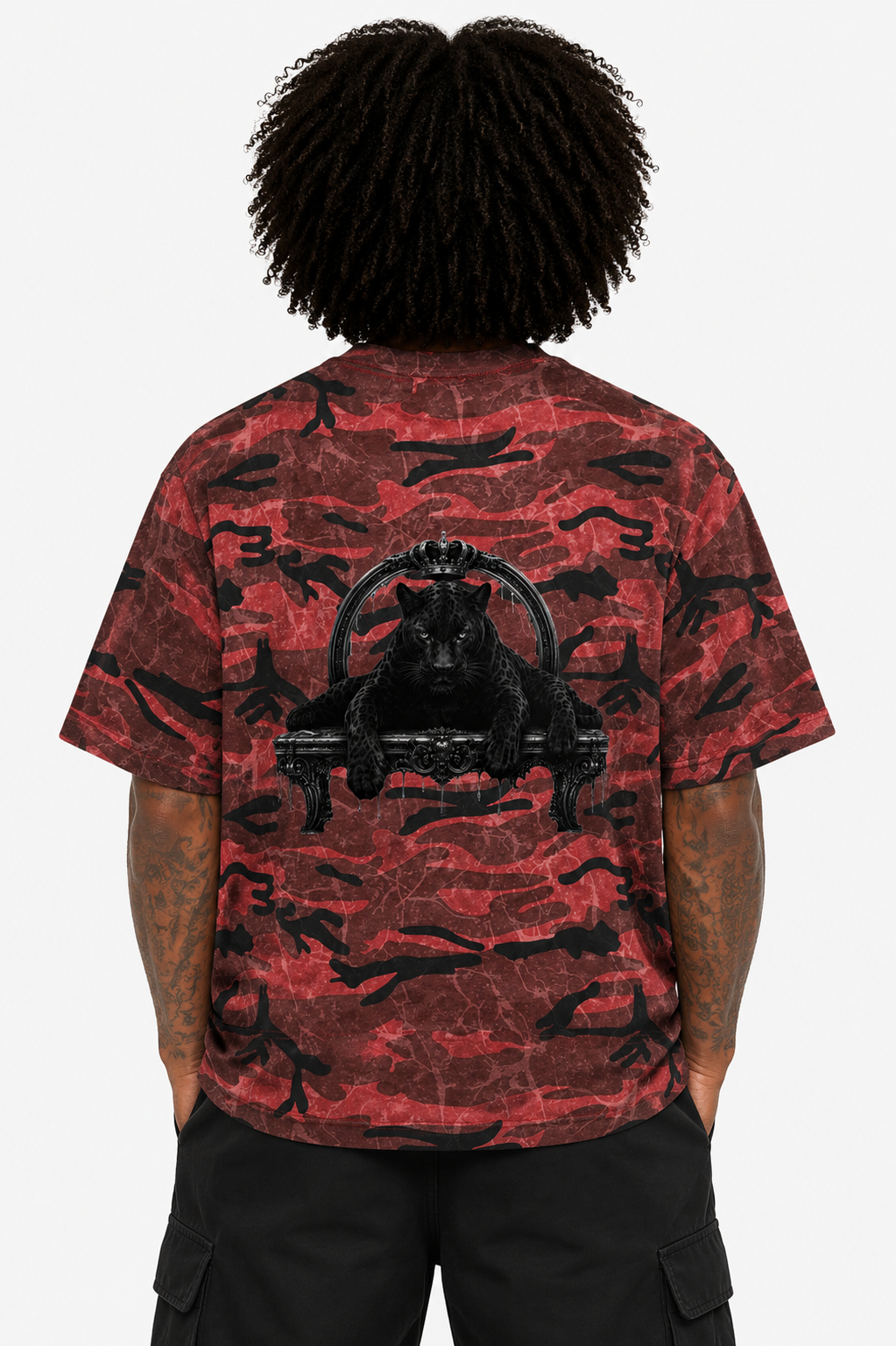 Person wearing a red and black camouflage t-shirt with a graphic design on the back.