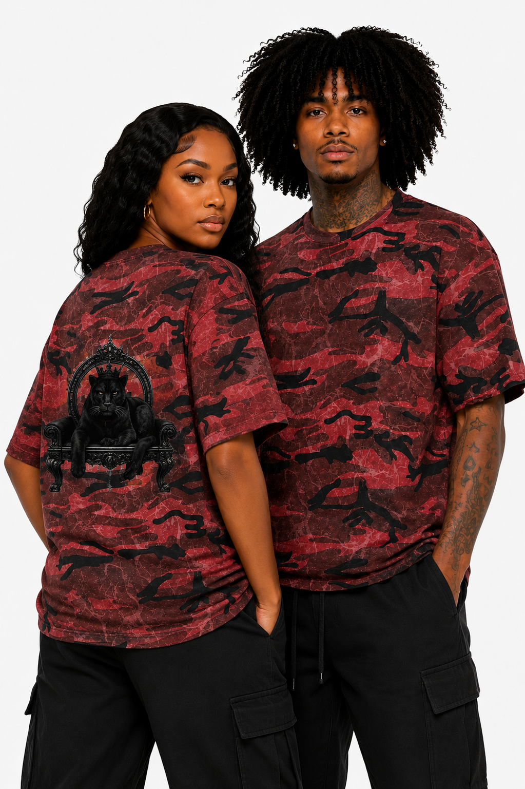 Two people wearing red and black camouflage shirts against a white background