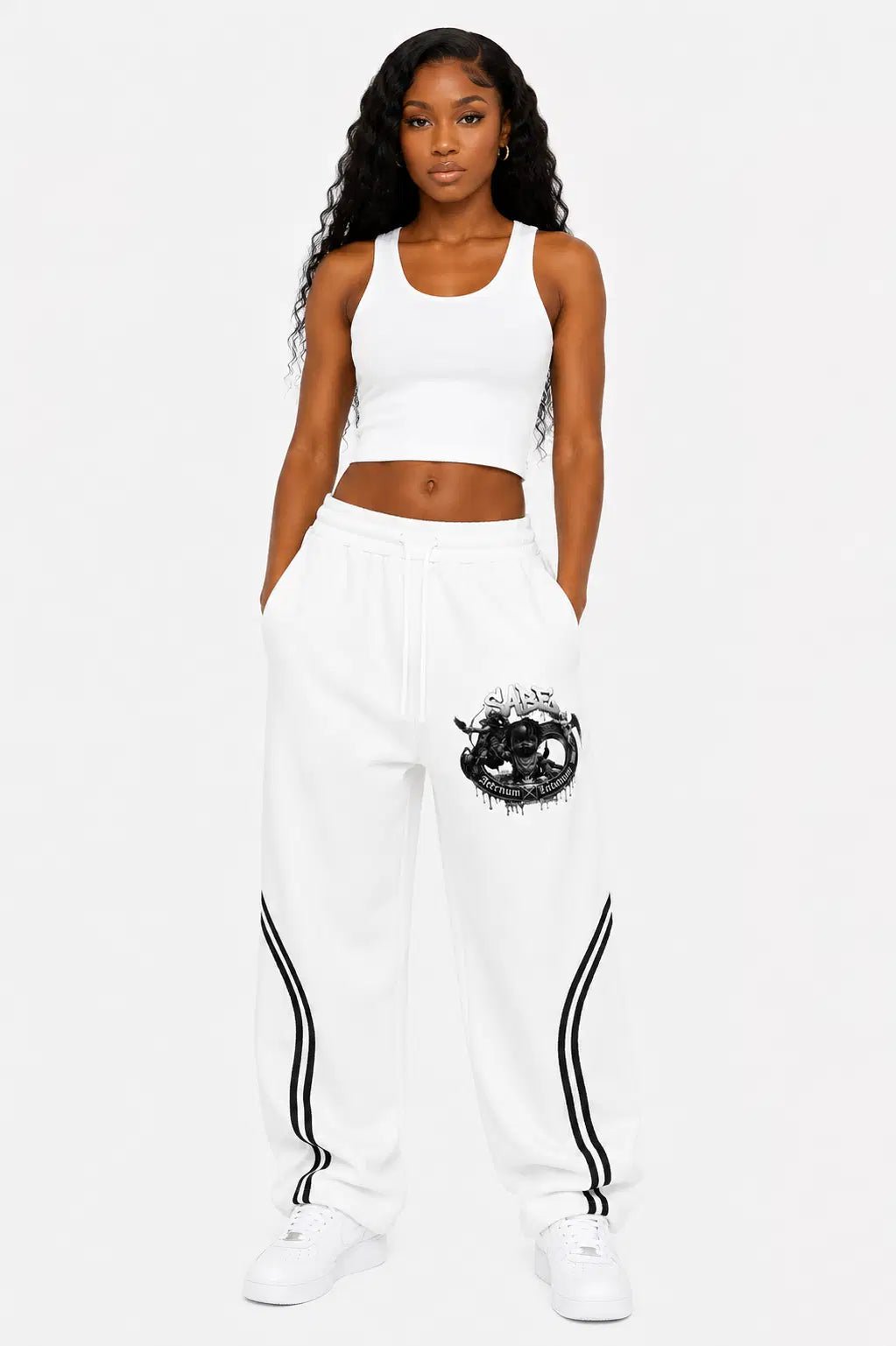 Woman wearing a white outfit with black designs on a white background
