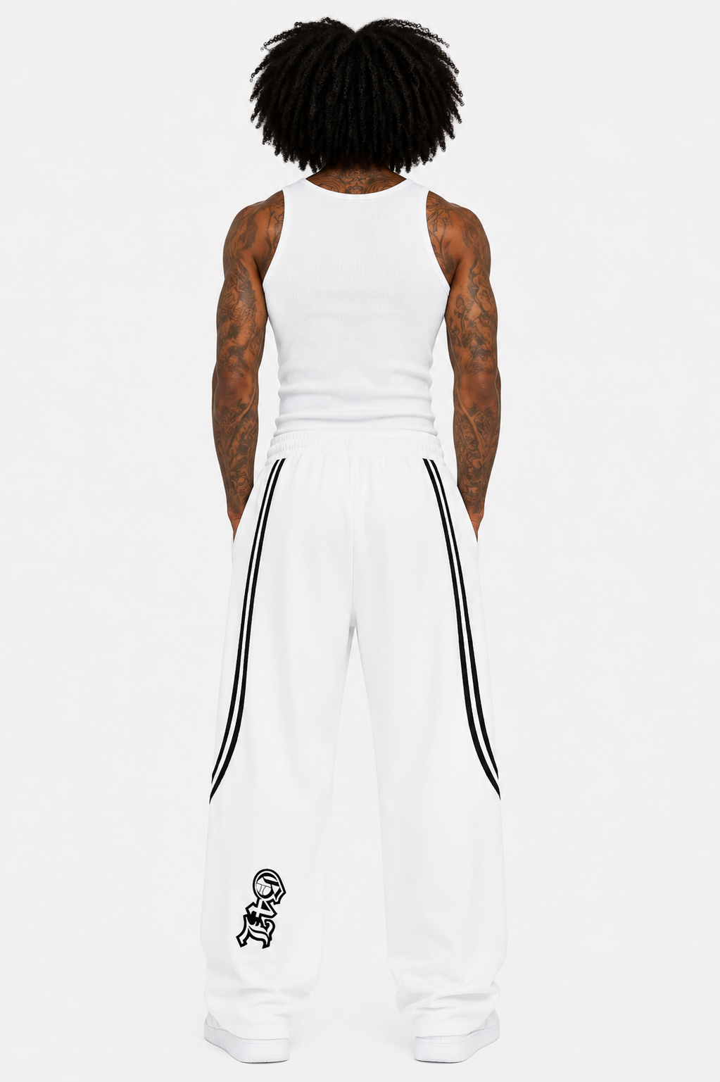 Person wearing a white sleeveless top and pants with black stripes on a white background