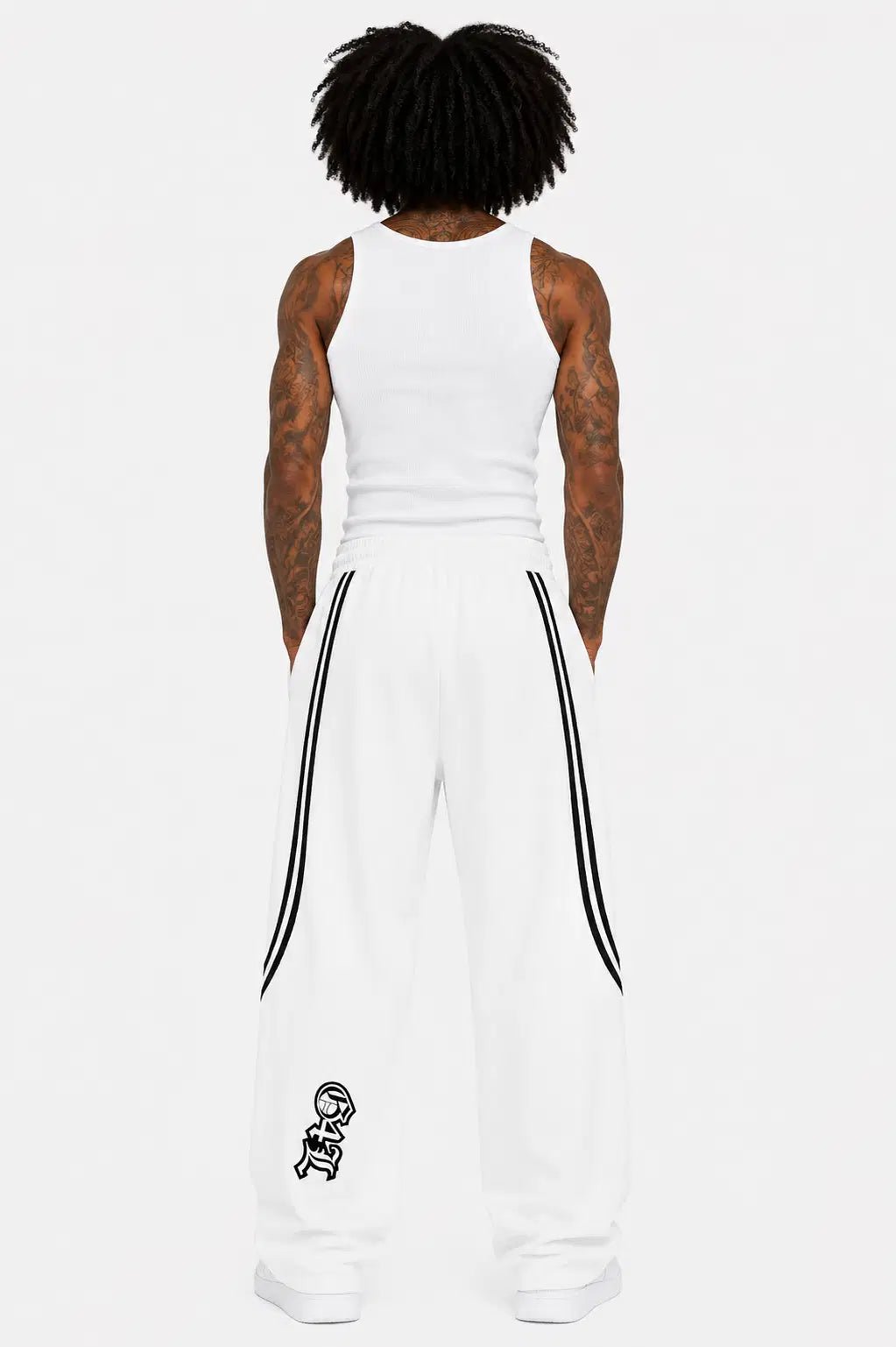 Person wearing a white sleeveless top and pants with black stripes on a white background