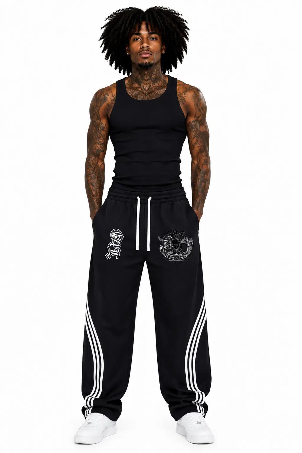 Man wearing black tank top and black pants with white stripes on a white background