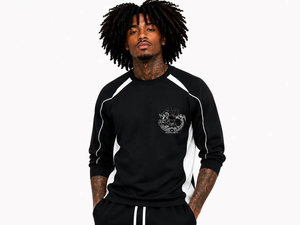 Person wearing a black long-sleeve shirt with white accents on a white background
