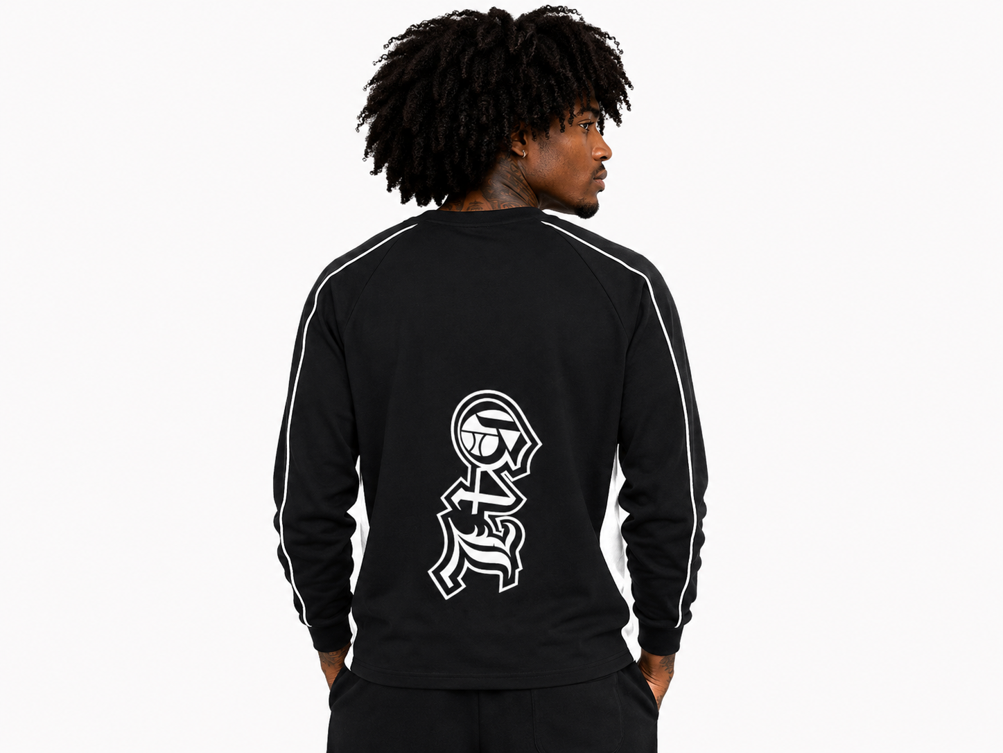 Person wearing a black tracksuit with a white logo on the back against a white background