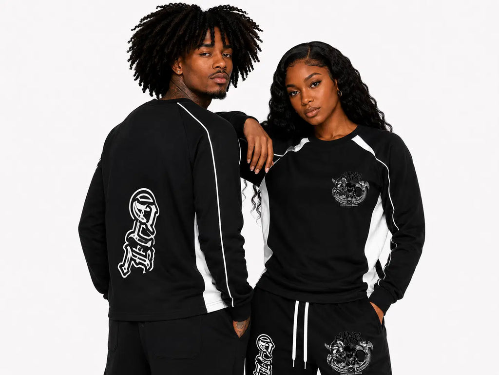 Two people wearing black tracksuits with white designs on a plain background