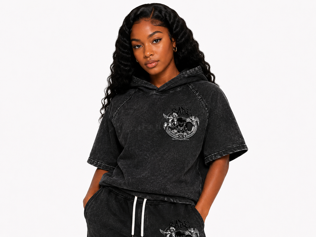 Woman wearing a black hoodie with a graphic design on a white background
