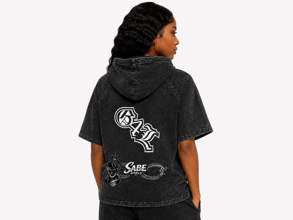 Person wearing a black hoodie with logos on the back against a white background