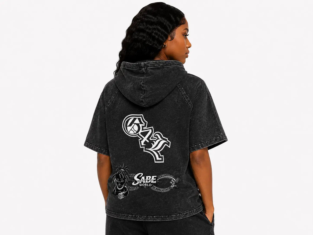 Person wearing a black hoodie with logos on the back against a white background