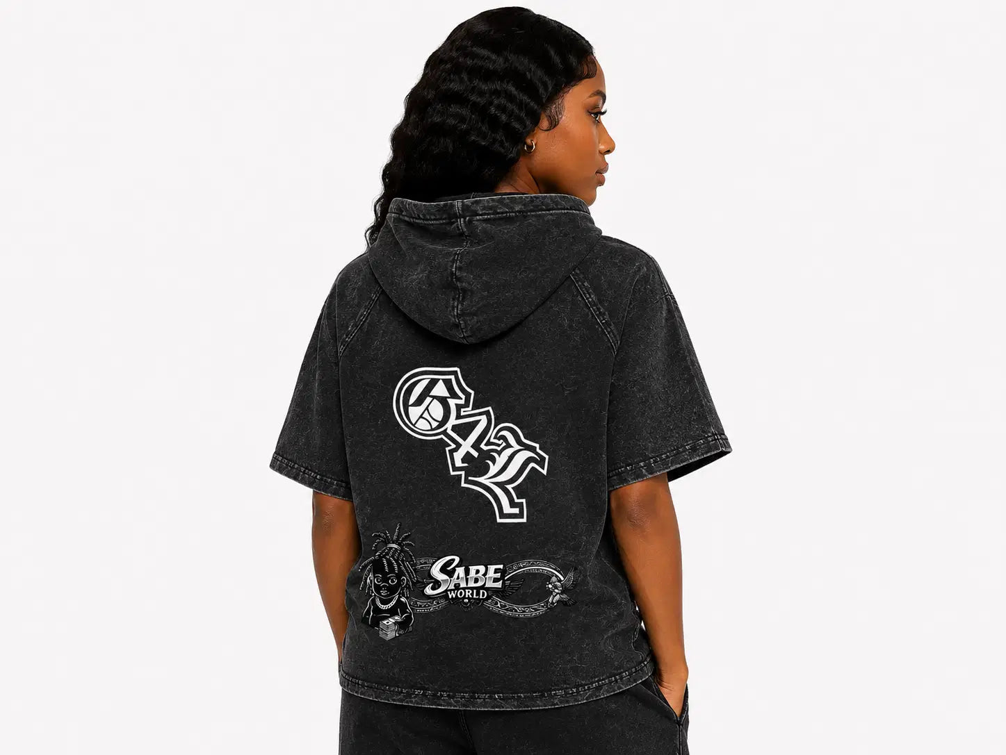 Person wearing a black hoodie with logos on the back against a white background