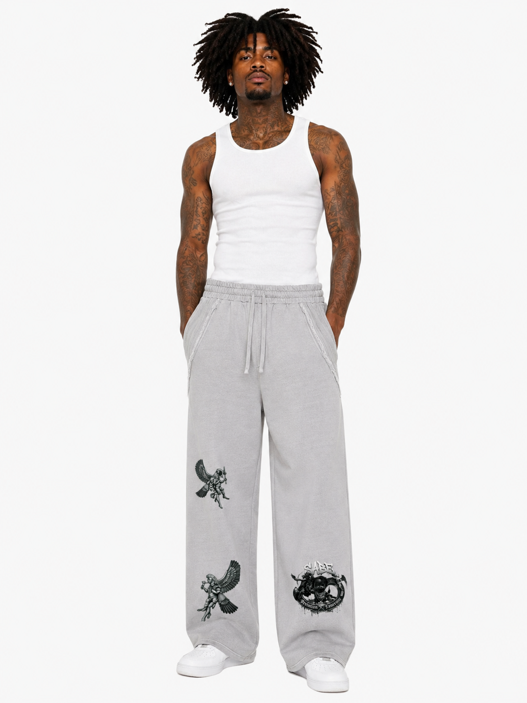 Person wearing gray sweatpants with black designs on a white background