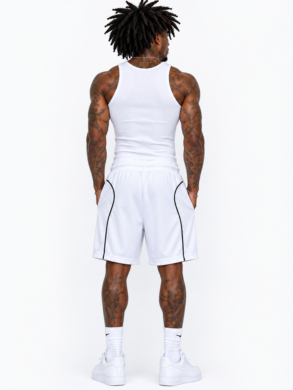 Person wearing a white tank top and shorts set on a white background
