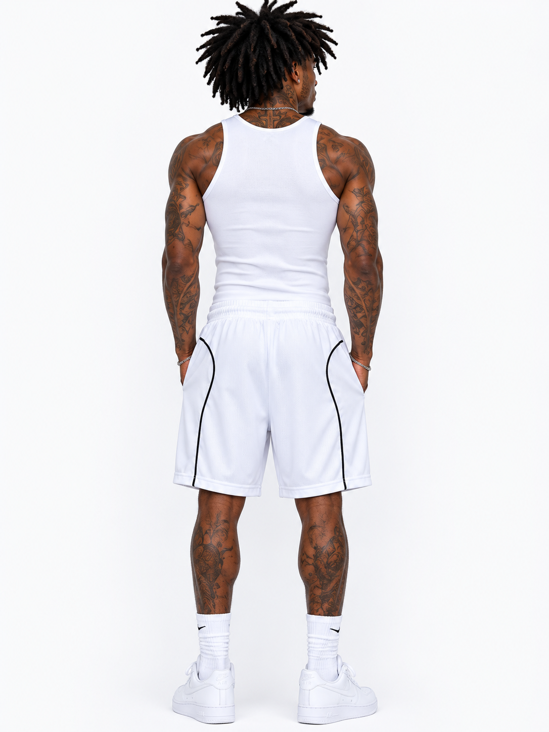 Person wearing a white tank top and shorts set on a white background