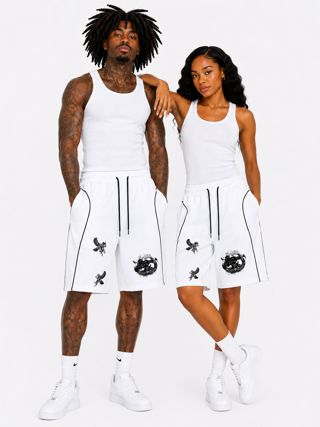 Two people wearing matching white outfits with black designs on a white background