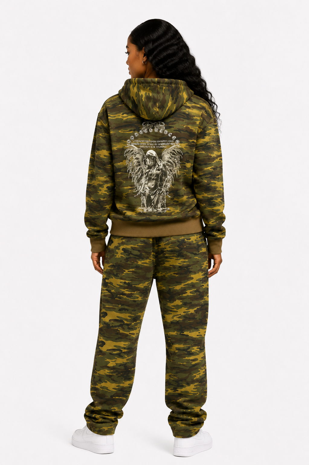 Person wearing a camouflage hoodie and pants set with a design on the back, on a white background