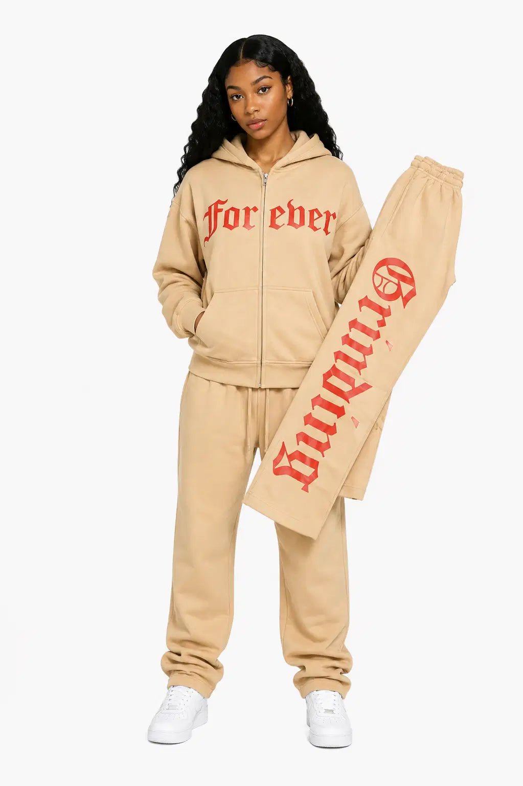 Person wearing a beige tracksuit with 'forever' text on a white background