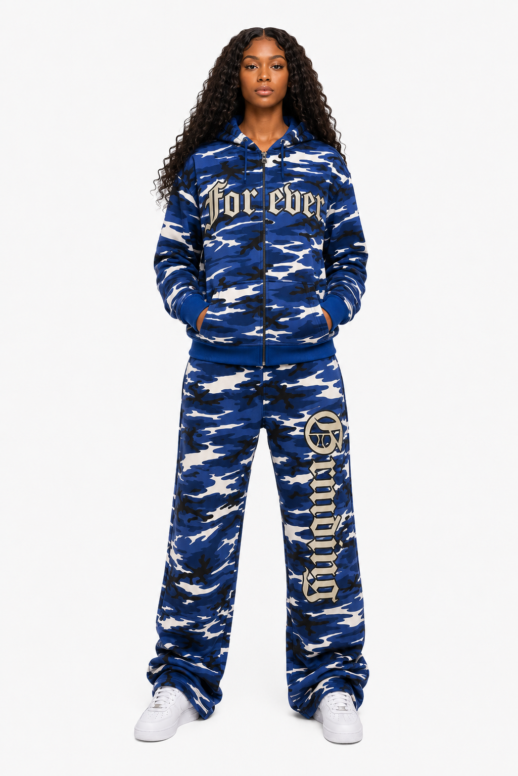 Person wearing a blue camouflage tracksuit with text on a white background