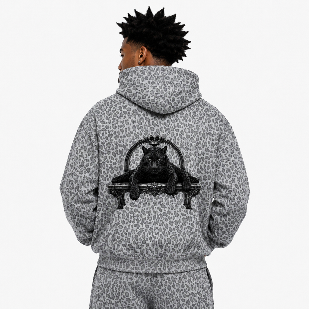 Person wearing a gray leopard print hoodie with a black panther design on the back, on a white background.