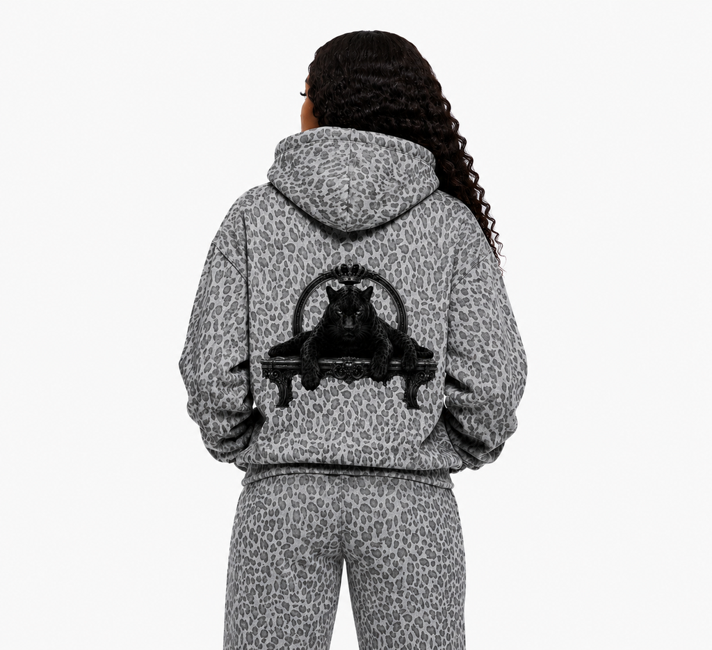 Person wearing a gray leopard print hoodie with a black panther design on the back, on a white background.